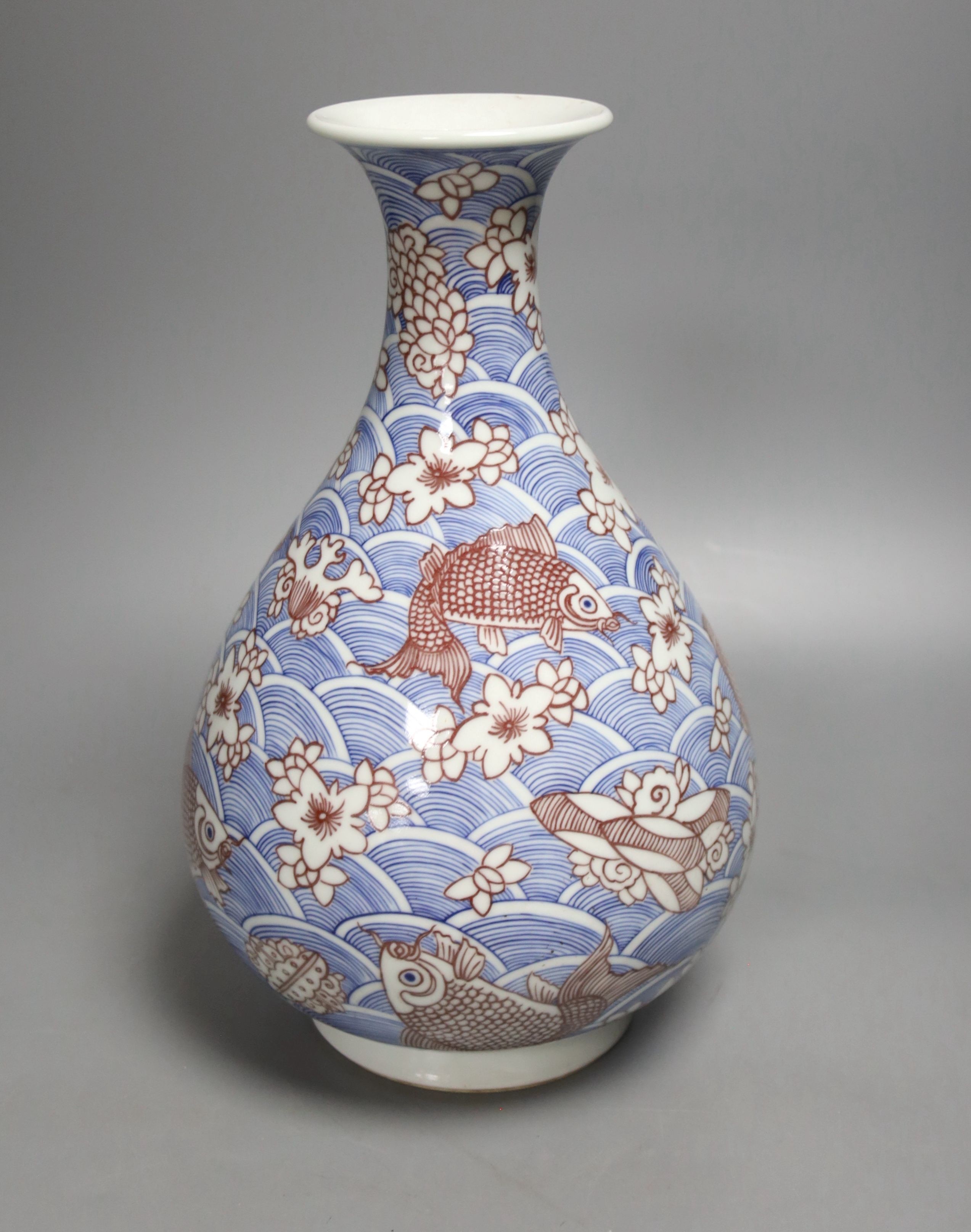 A Chinese underglaze blue and copper red pear-shaped vase, 31 cms high.
